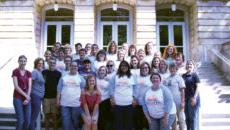 Group of legacy students and their family pose for a group photo on the steps of the conservatory of music.